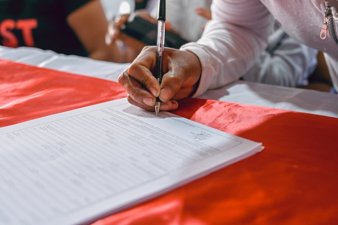 person writing on white paper